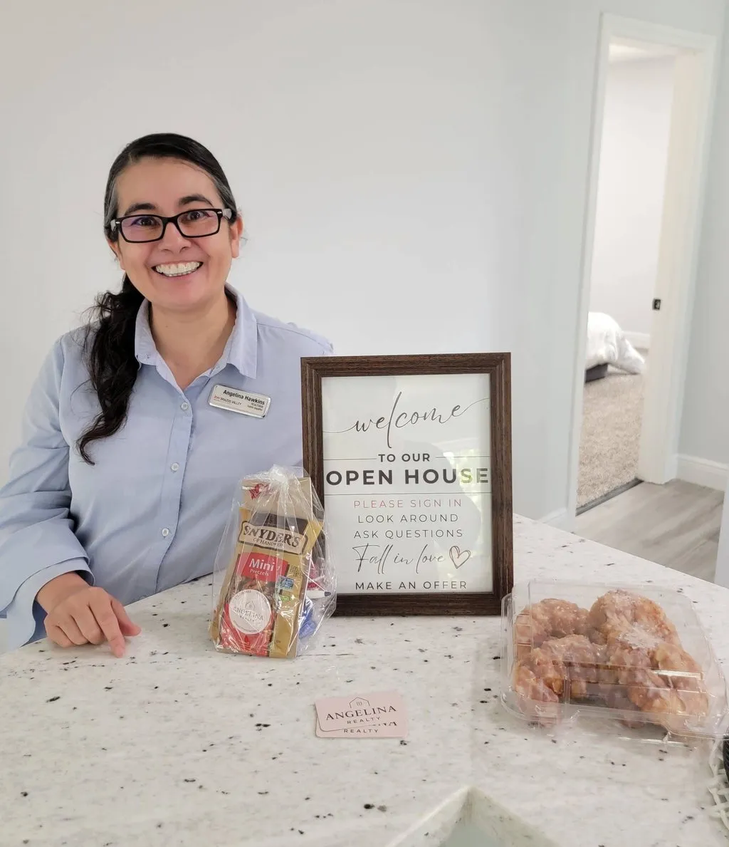 Angelina Hawkins welcoming visitors at an open house